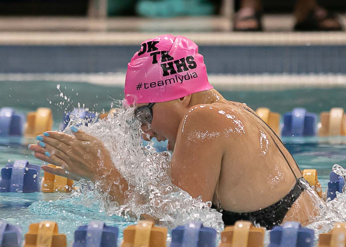 Lydia swimming during a competition