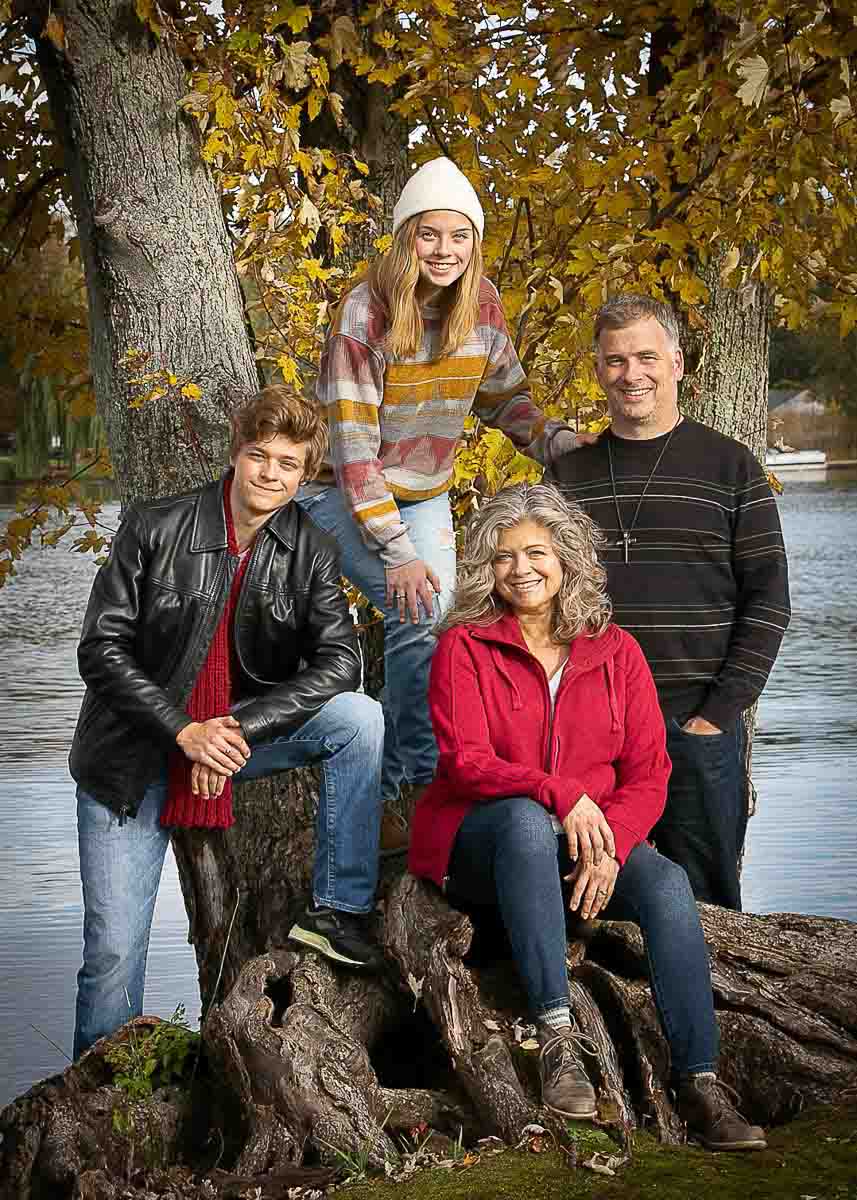 Family standing by a tree with river backdrop