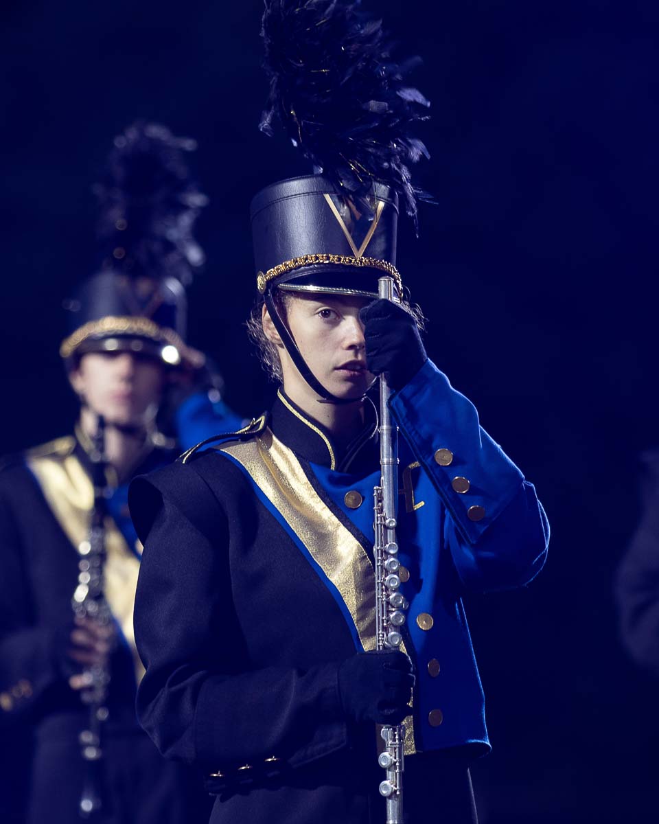 Daughter holding flute in marching uniform
